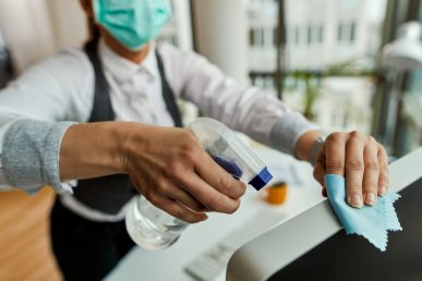 Close-up of businesswoman cleaning her computer while working in the office.